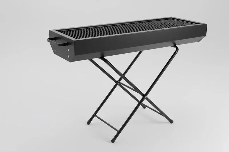 Foldable charcoal BBQ grill by CSSV FILE with a compact, portable design and grilling surface, ideal for outdoor cooking.